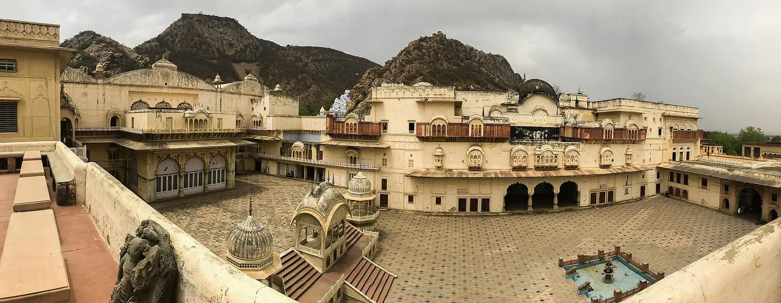 The cream-coloured City Palace courtyard in Alwar below the Aravalli hills