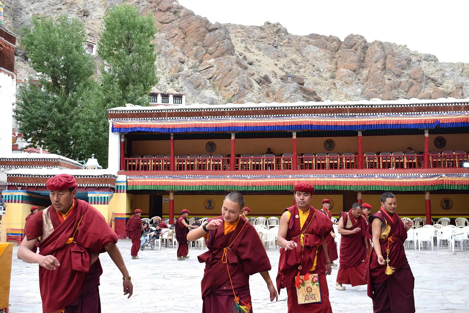 Monks crossing the courtyard of Hemis Monastery in Ladakh