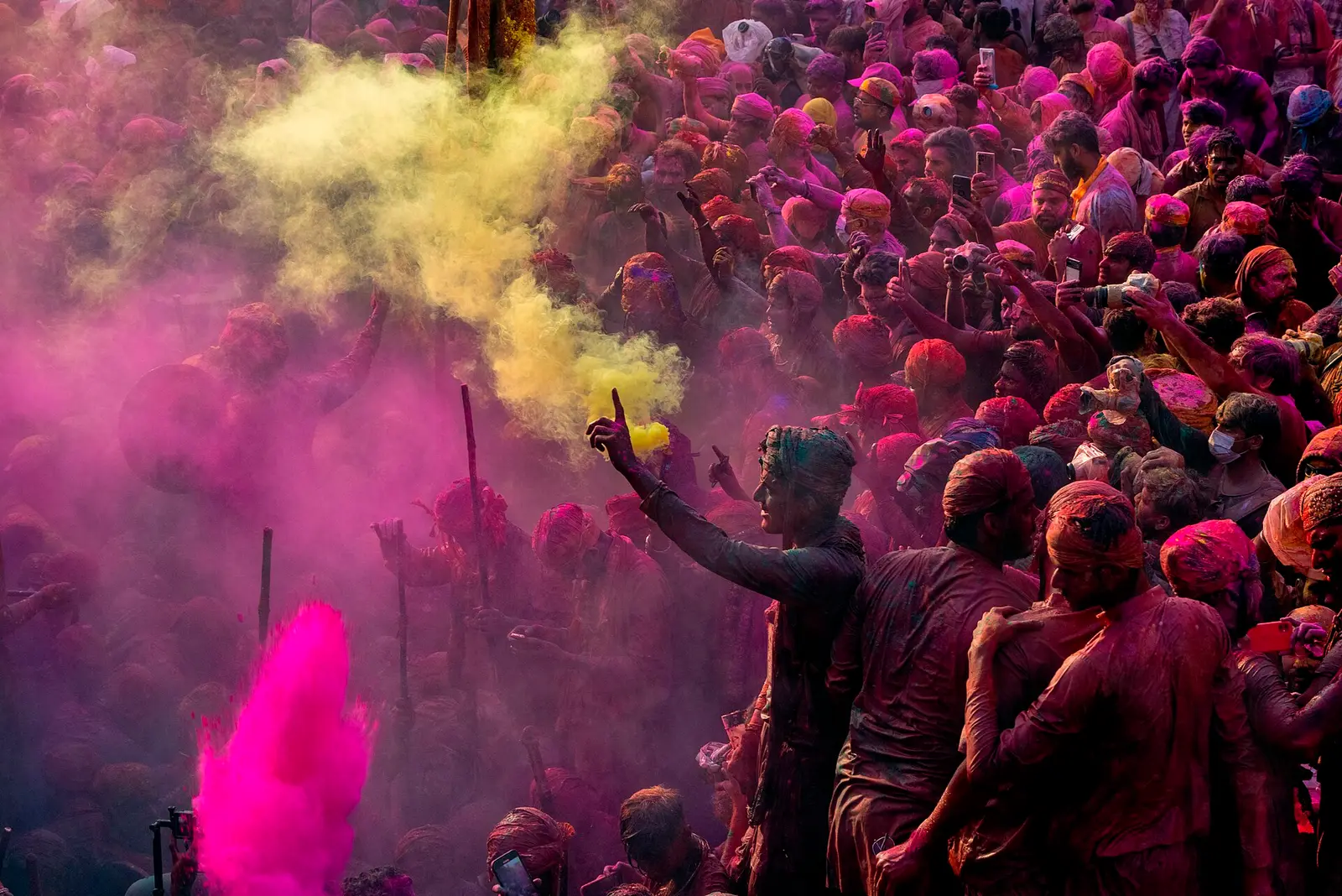 Crowd covered in coloured powder during Holi celebrations in India