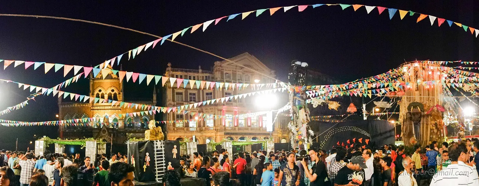 Crowd under bunting at night during Kala Ghoda Arts Festival in Mumbai