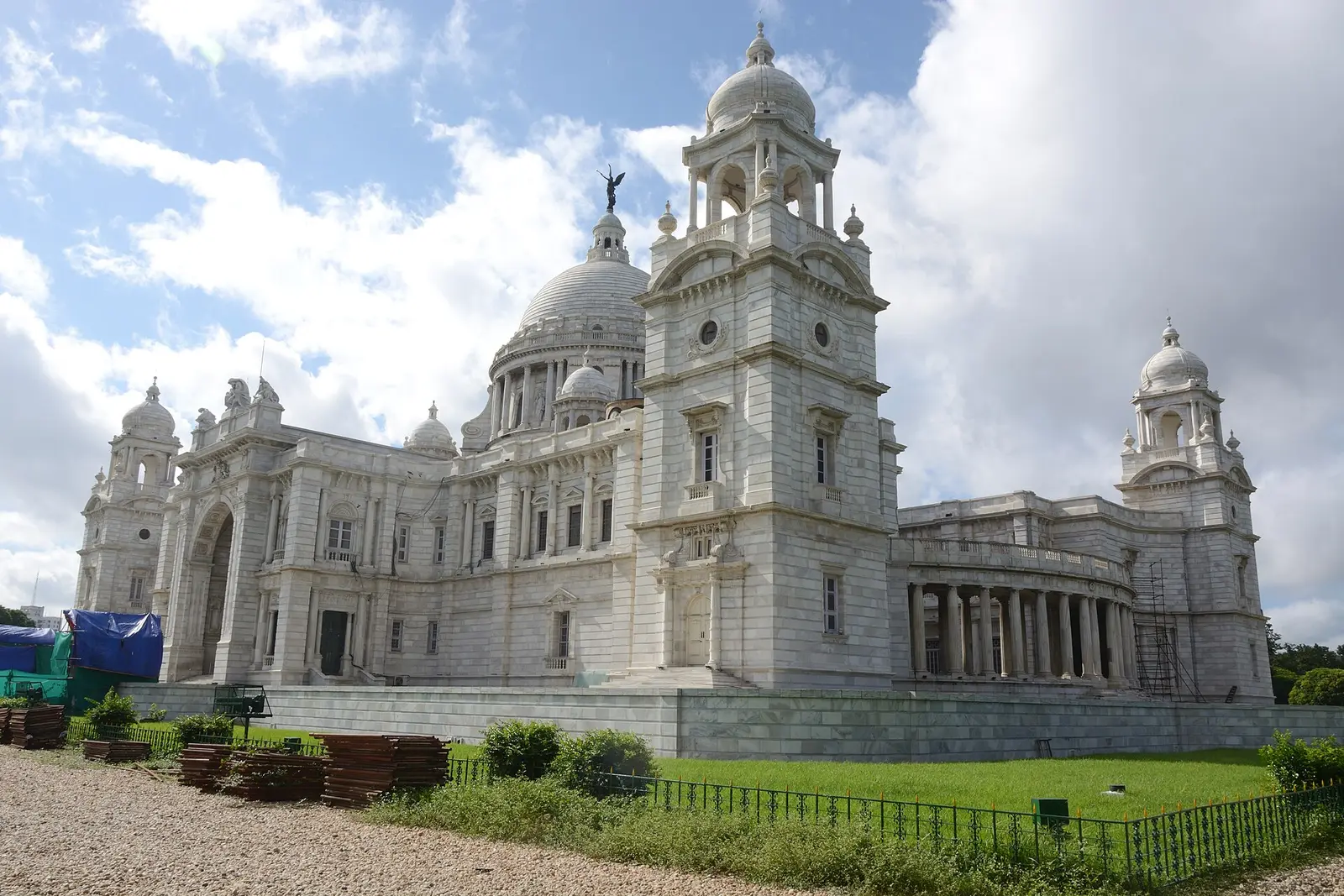 Victoria Memorial in Kolkata under a blue sky with clouds